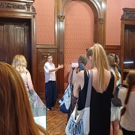 group of people in the Zygmunt Krauze exhibition space. Creative Archive, listening to the educator leading the tour