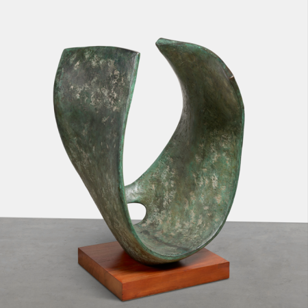Curved bronze sculpture on a wooden platform