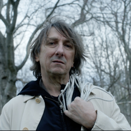 portrait of a man, with a background of trees