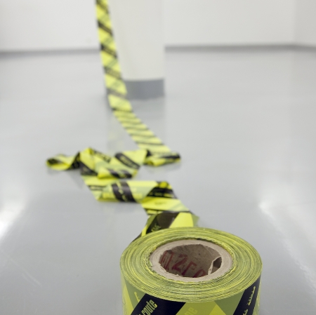 Artwork, tape in yellow and black stripes, tangled around pole