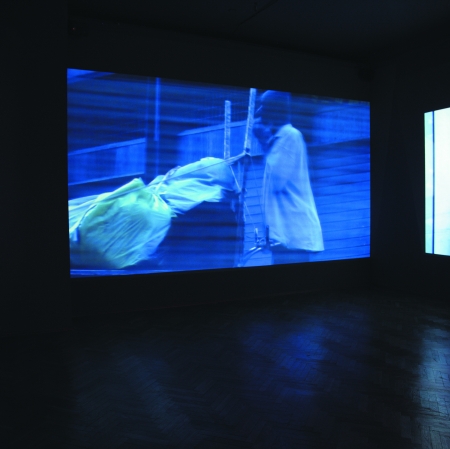 exhibition view with films displayed on the walls 
