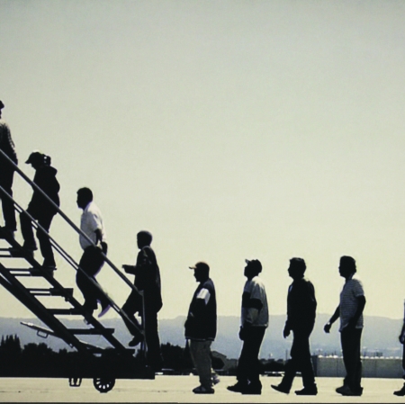 Photo of an artwork, People going up the stairs to the plane without the plane, different angle