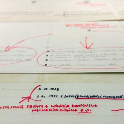 Handwritten text document with corrections, circles, and arrows drawn in red ink.