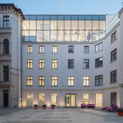 A white building with lights on in the windows