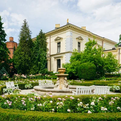 A green garden, a bright palace building in the distance