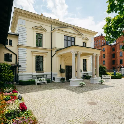 A color photo of the building, the facade is in bright colors